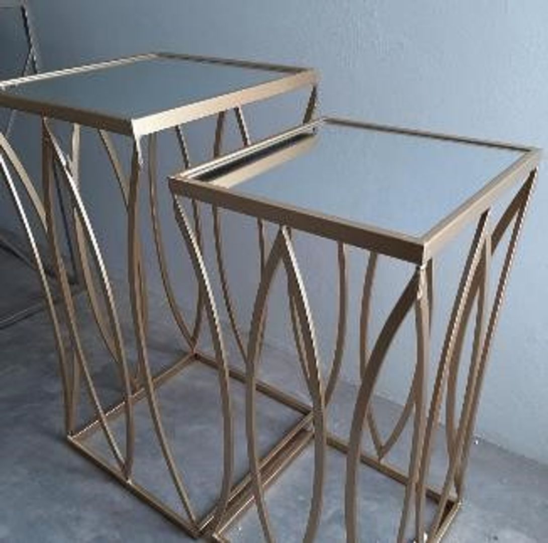 Set de dos mesas doradas con espejo.