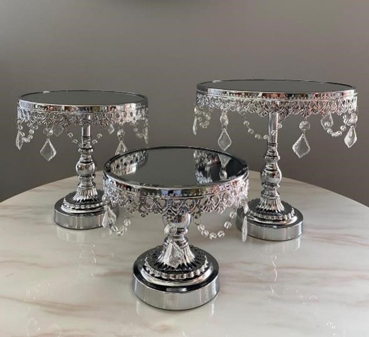 Set de tres bases en metal color plateado con espejo