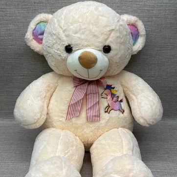 Imagen del producto OSO PATAS LARGAS BLANCO CON BORDADO DE UNICORNIO TORNASOL 75 CM 